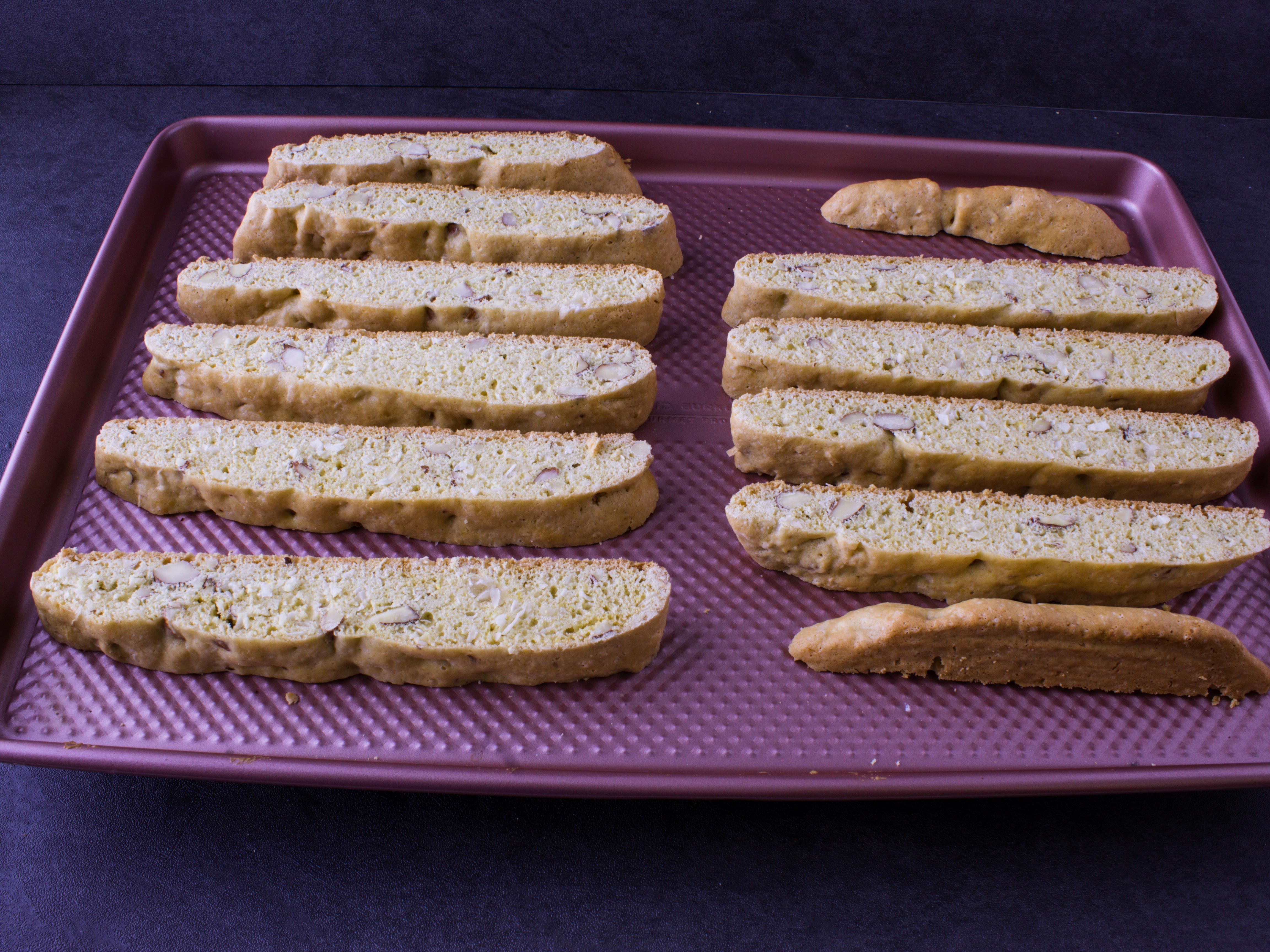 sliced coconut biscotti placed on a baking tray before going into the oven