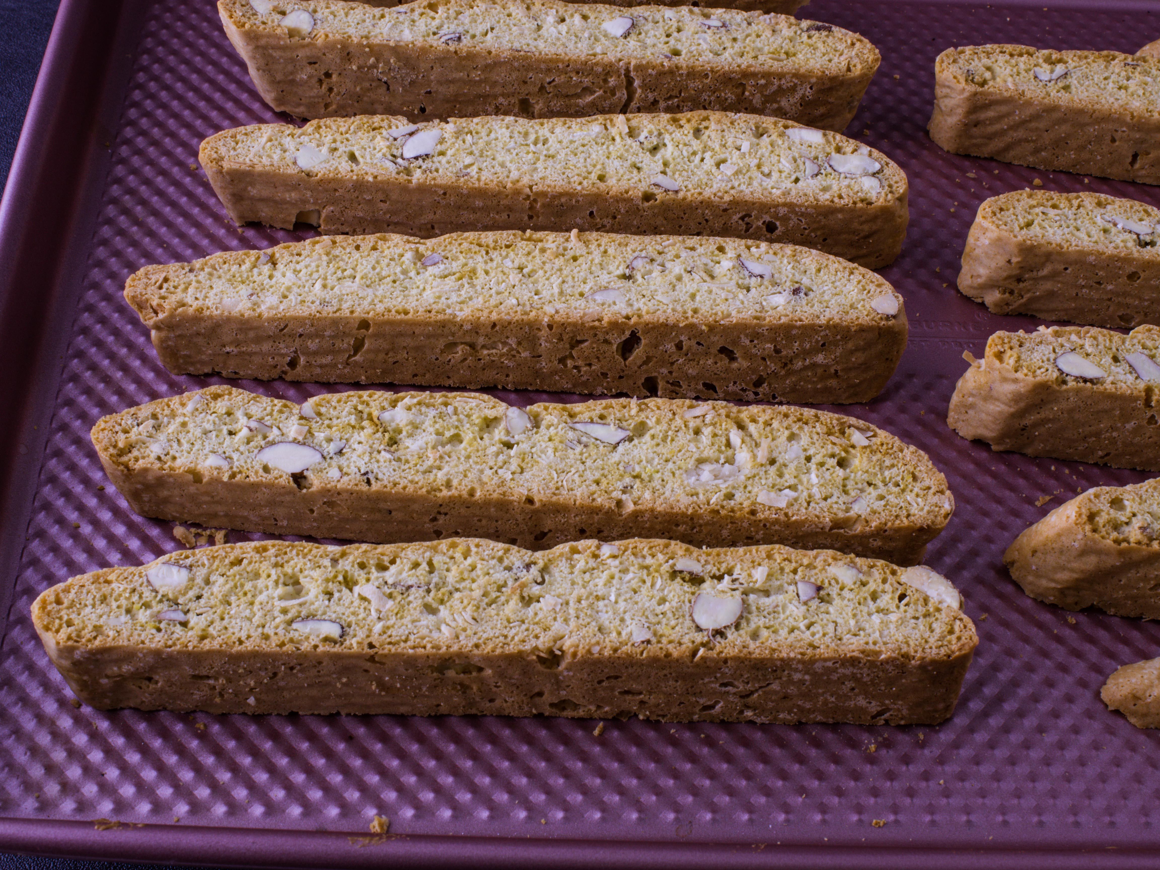 biscotti that are golden and crisp on a baking sheet after they have finished baking 