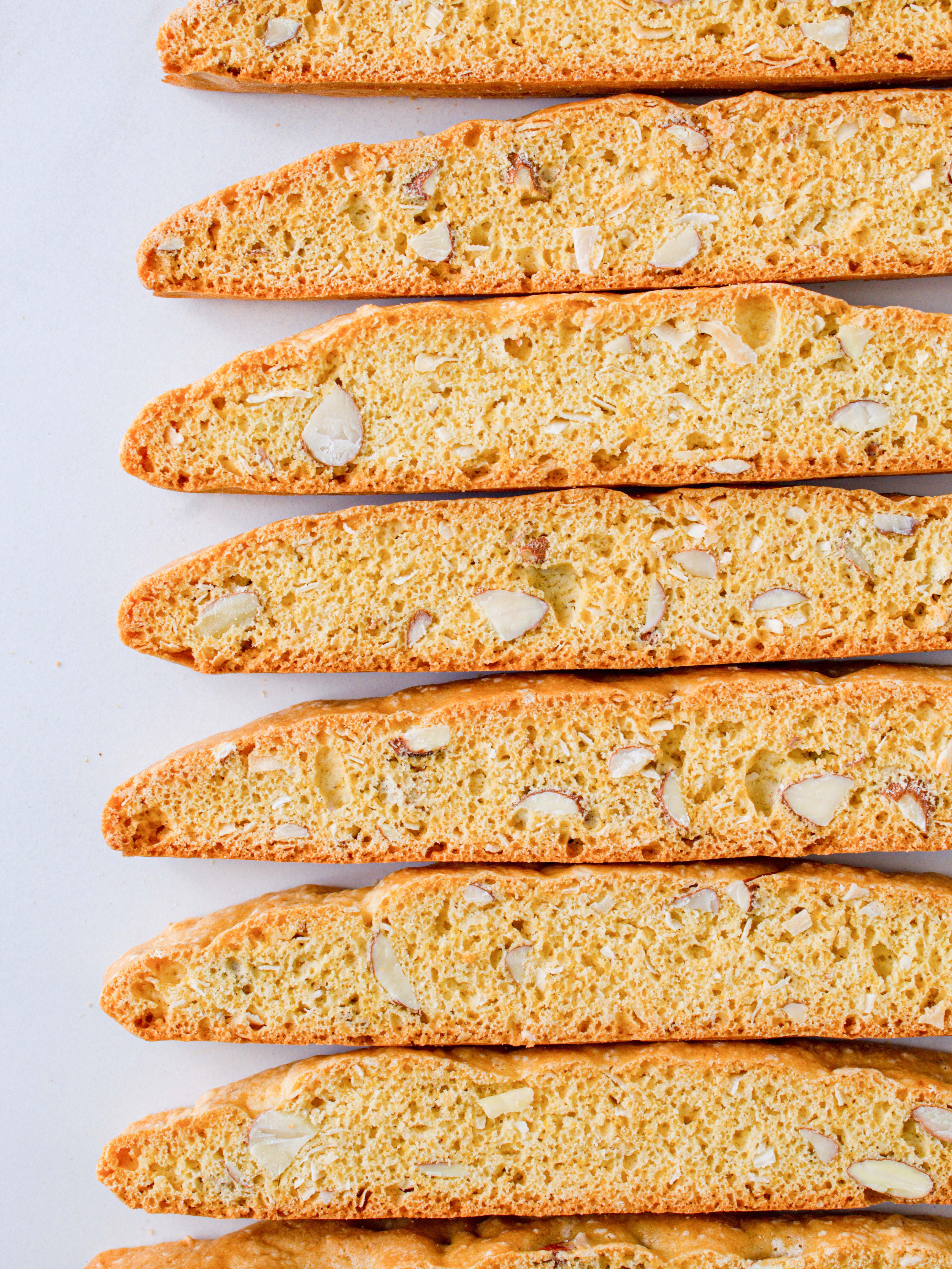 many coconut biscotti lined up with a marble backgrround